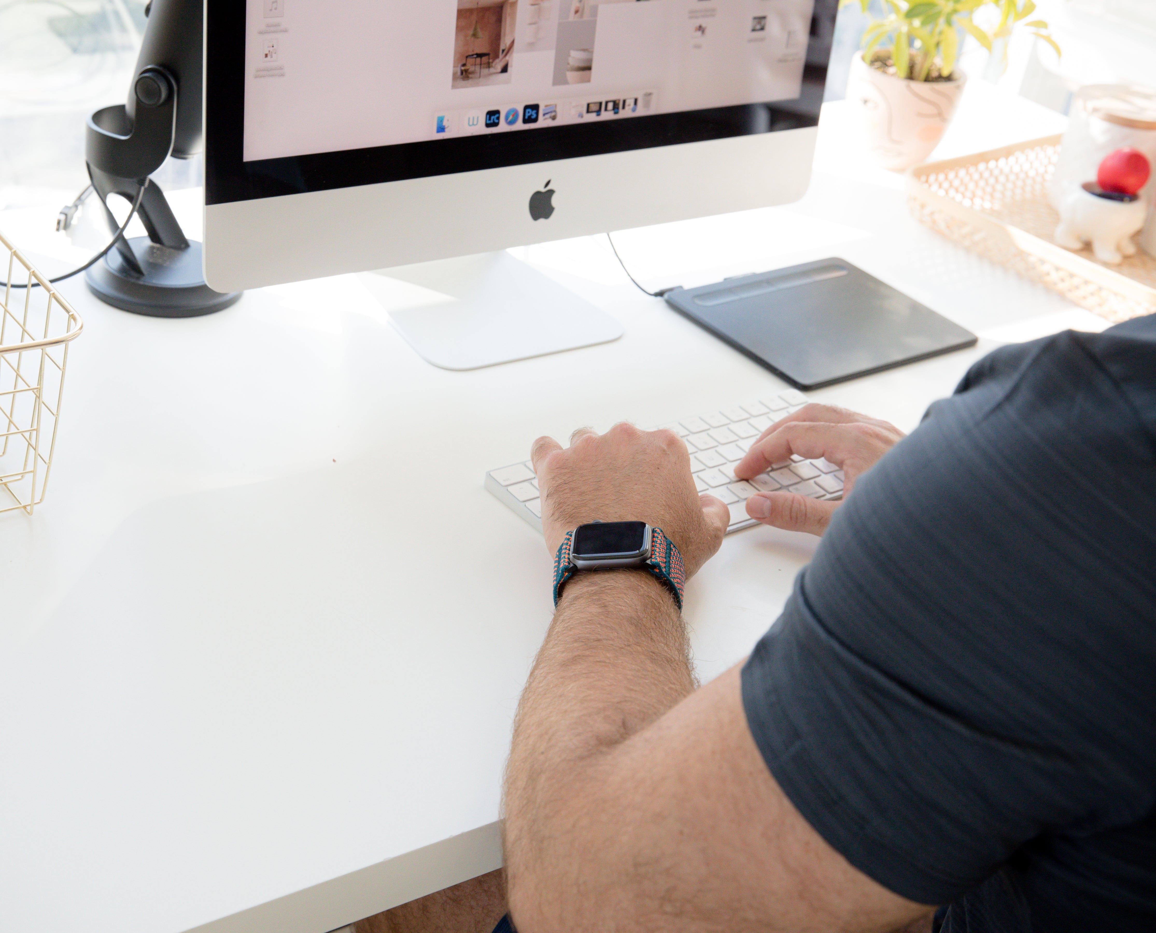Person working at a clean white desk
